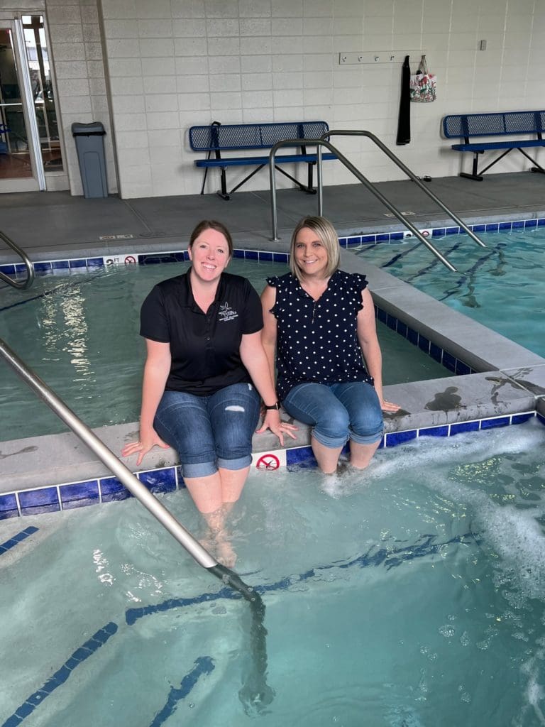 Camper and counselor at the pool during no limits summer camp at The Arc of the Ozarks